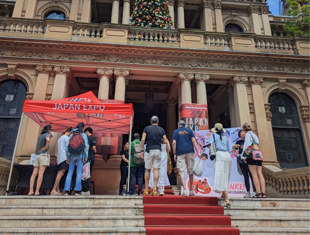 JAPAN EXPO 2024 attendees walking up red carpet stairs leading into Sydney Town Hall