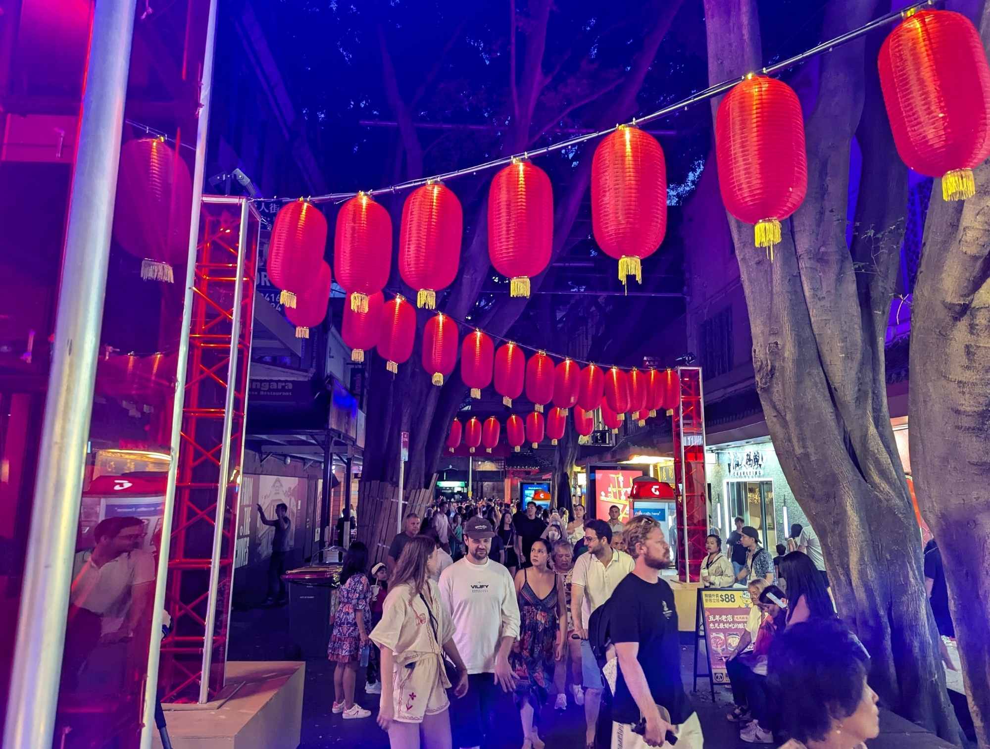 Glowing red lanterns on Dixon Street near Market City during Lunar New Year 2025