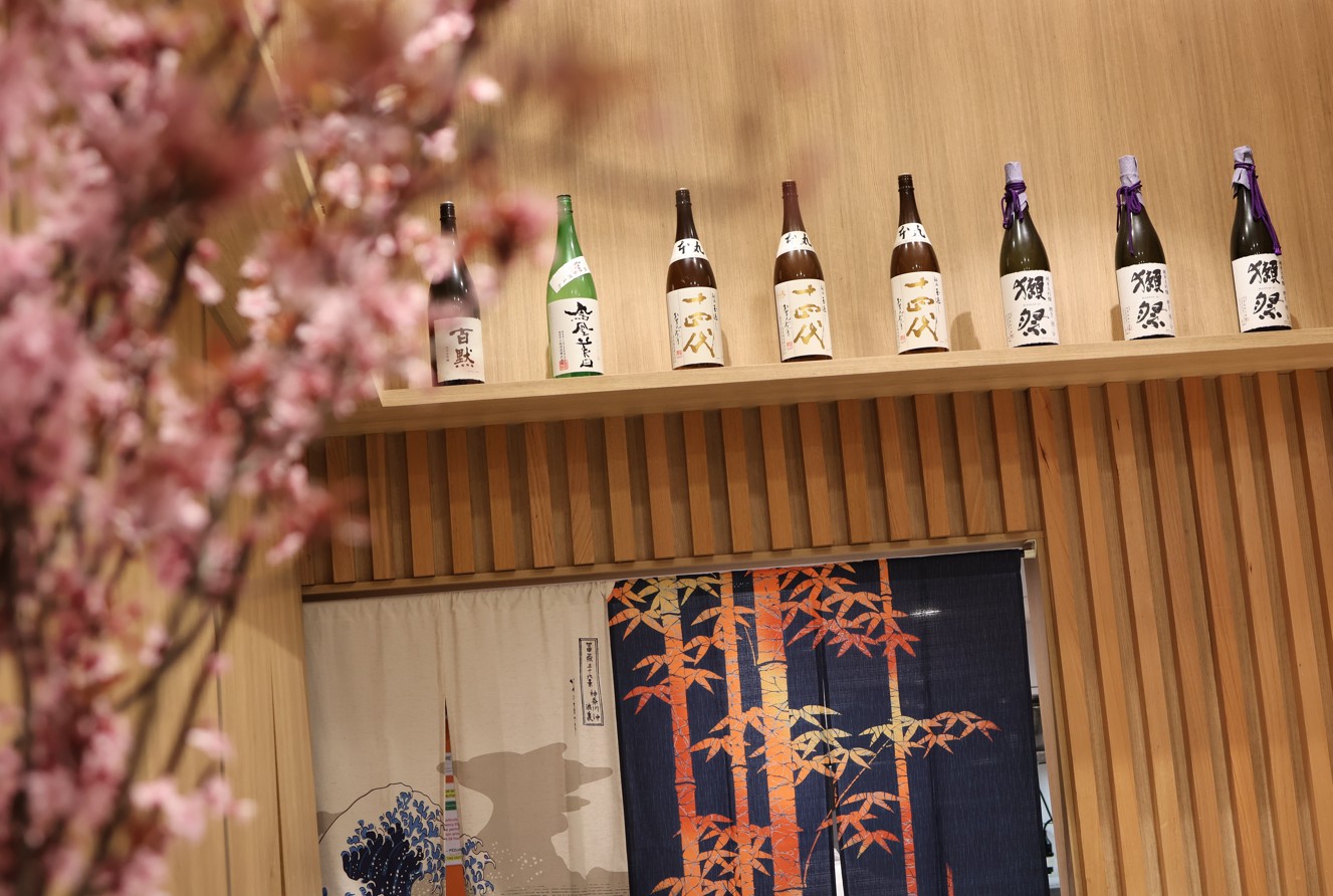 Japanese sake bottles on wooden panel in fitout of Sushi Sei